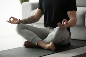 Man meditating on a yoga mat